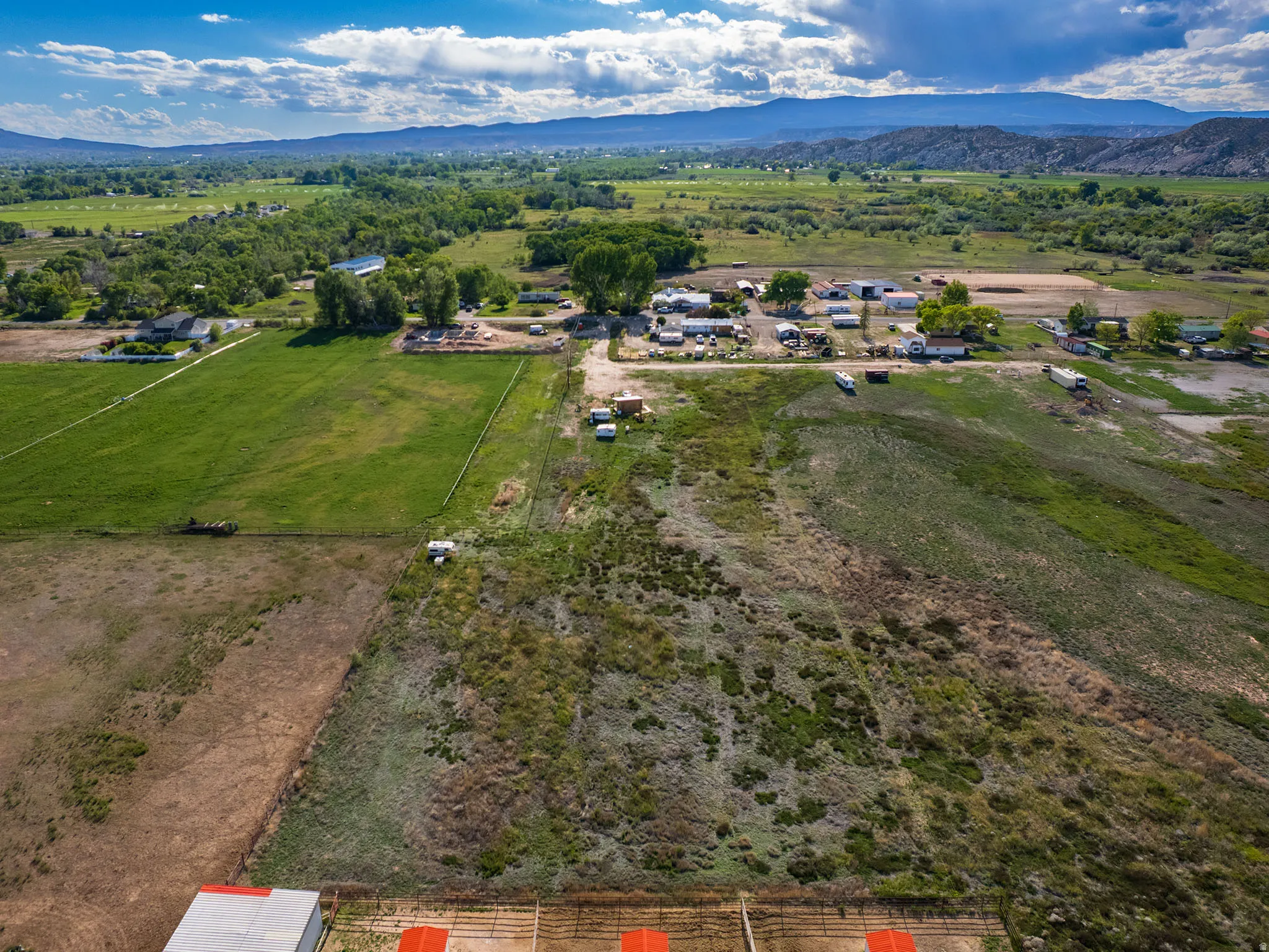 Expansive rural property featuring a mix of green fields and natural terrain