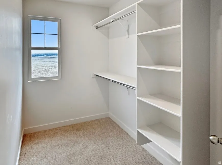 White closet system featuring integrated shelving and hanging rods