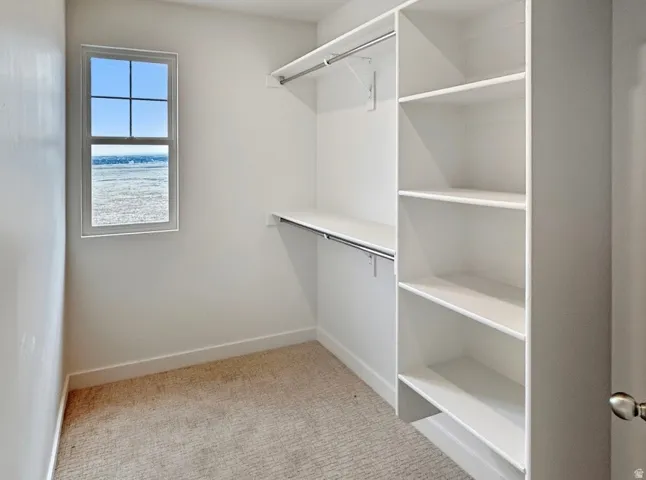 White closet system featuring integrated shelving and hanging rods