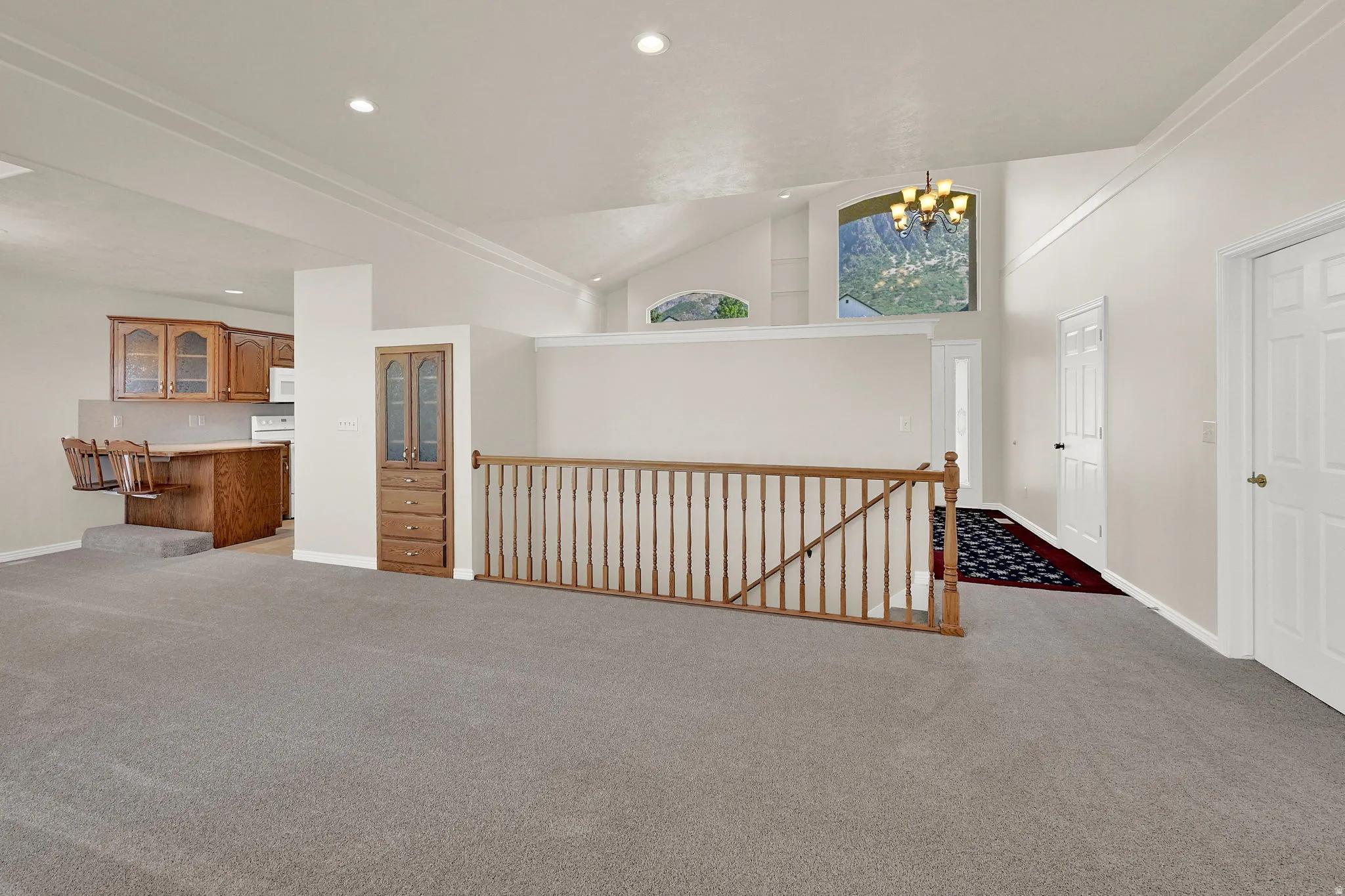 Expansive interior featuring vaulted ceilings and recessed lighting