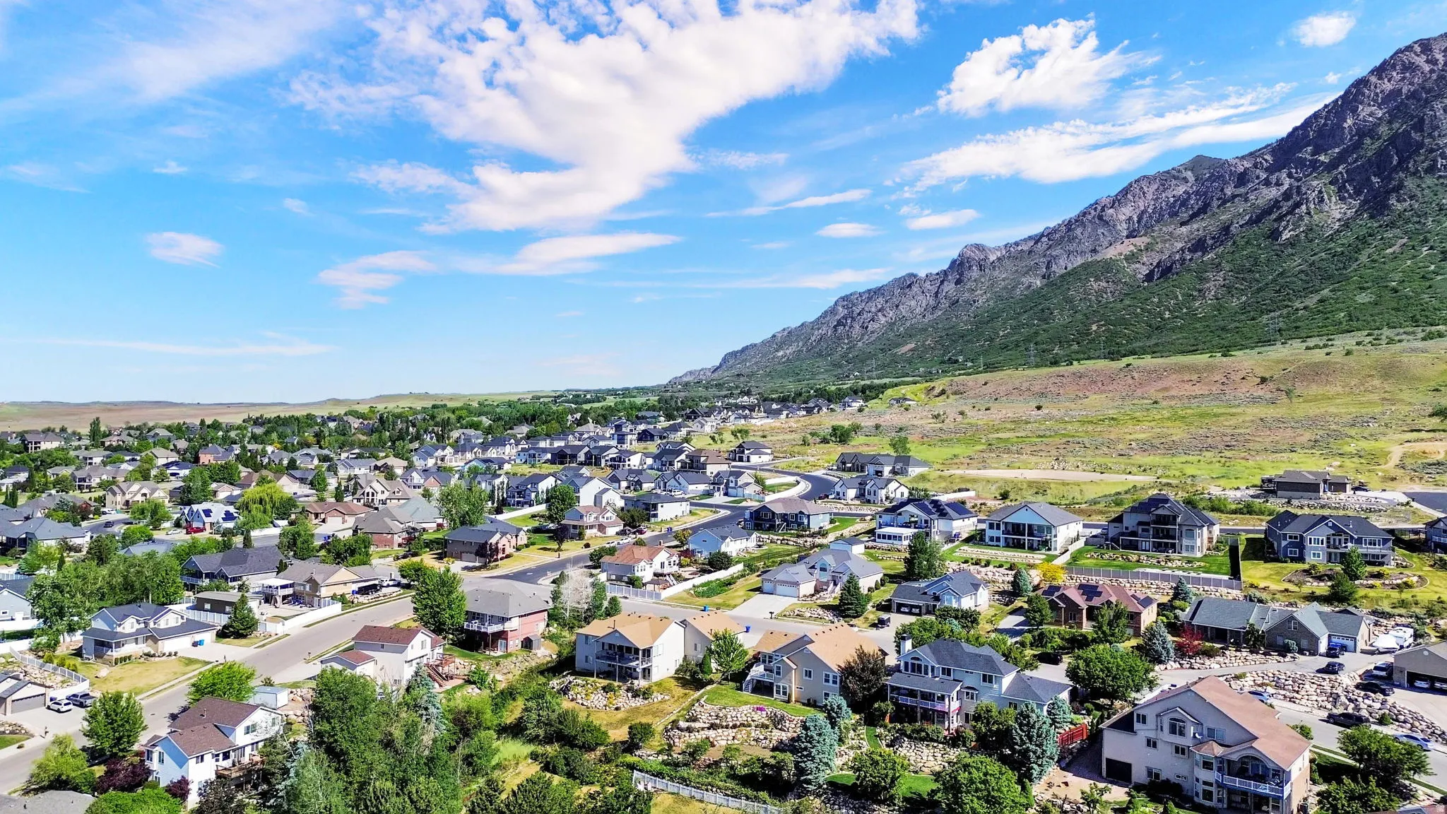 Residential neighborhood featuring a diverse collection of single-family homes with a mountainous backdrop