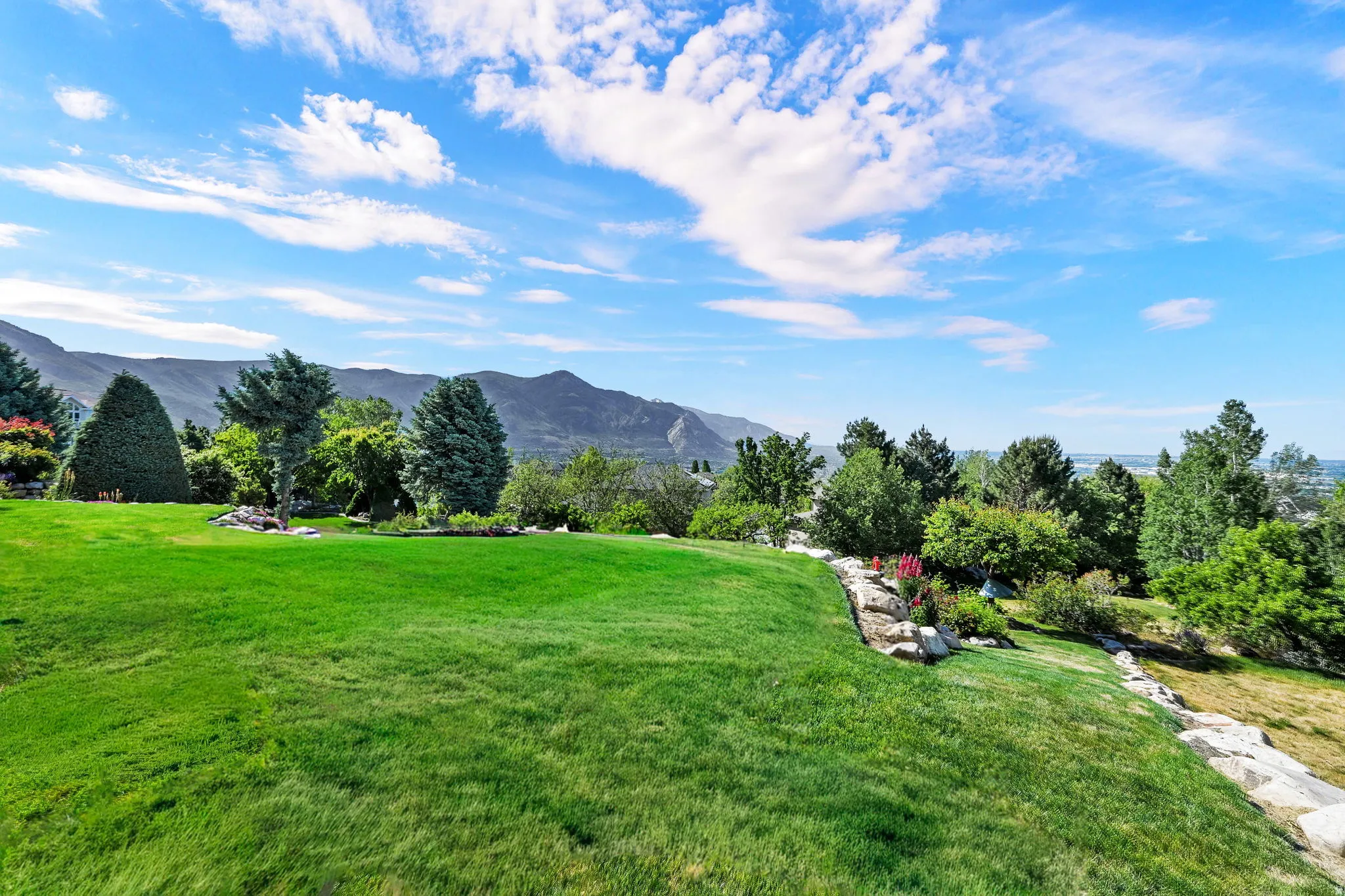 Expansive green lawn with mountain backdrop