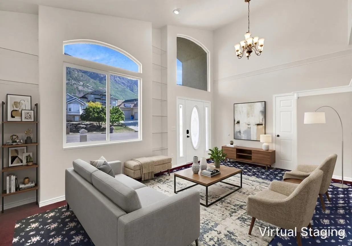 Grand living room featuring an arched transom window, high ceilings, crown molding, and a prominent chandelier