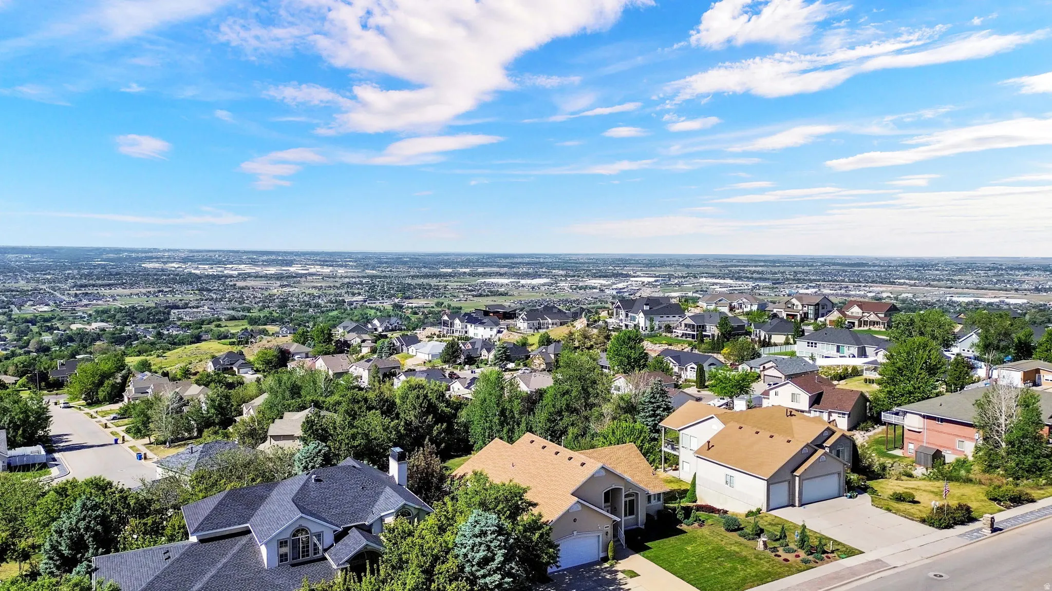 Expansive aerial perspective showcasing a residential area with a far-reaching horizon
