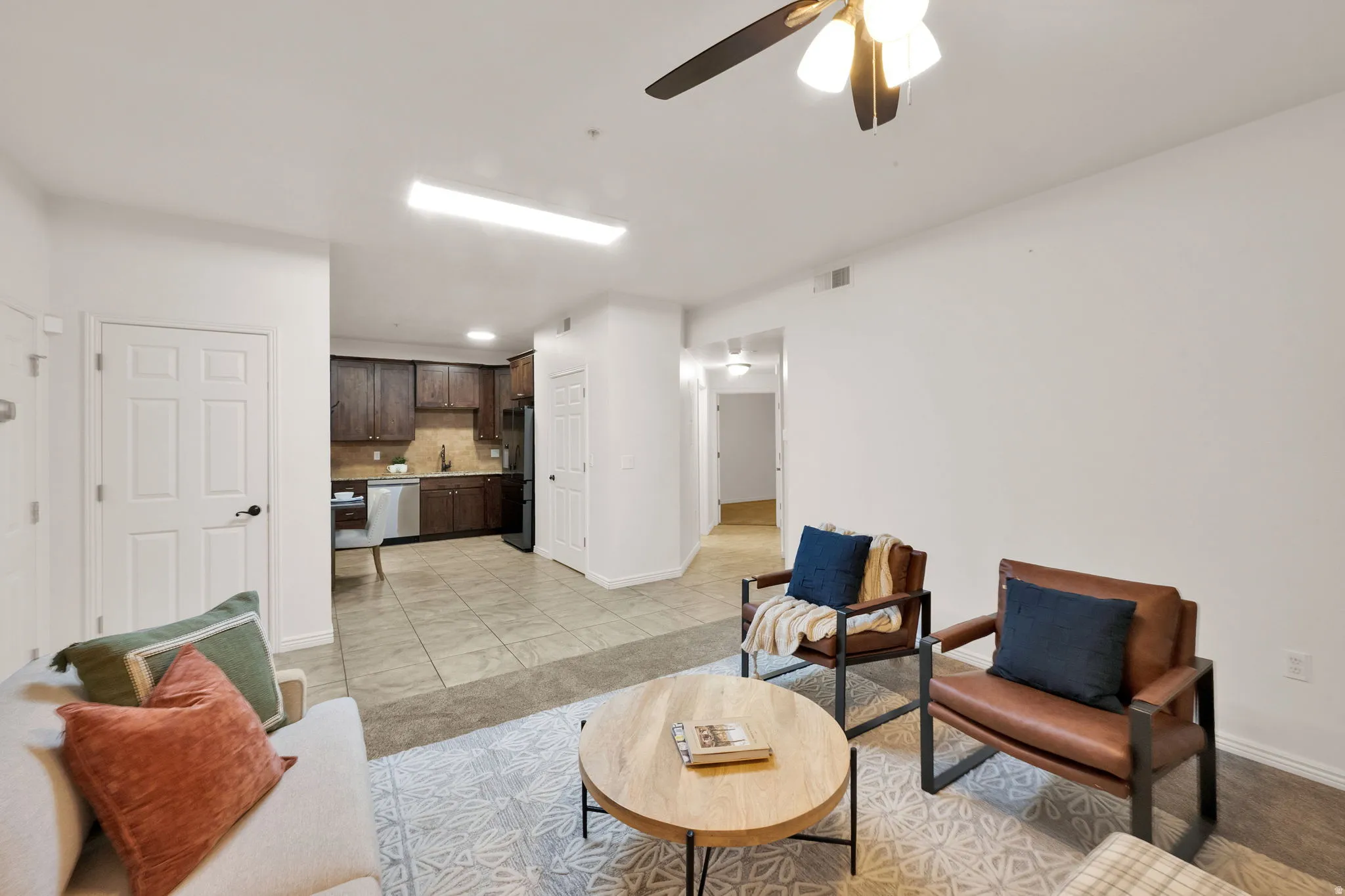 Open-concept living area with a ceiling fan, recessed lighting, and white baseboards