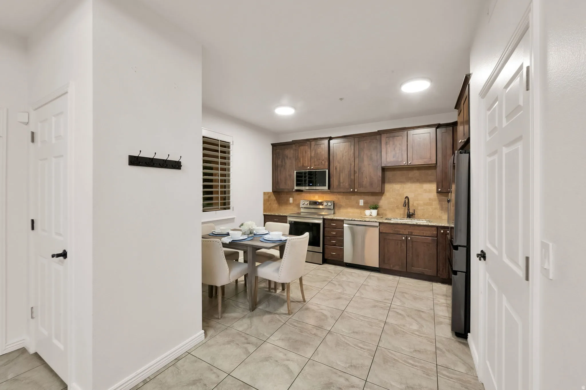Kitchen featuring wood-finish cabinetry, granite countertops, and stainless steel appliances