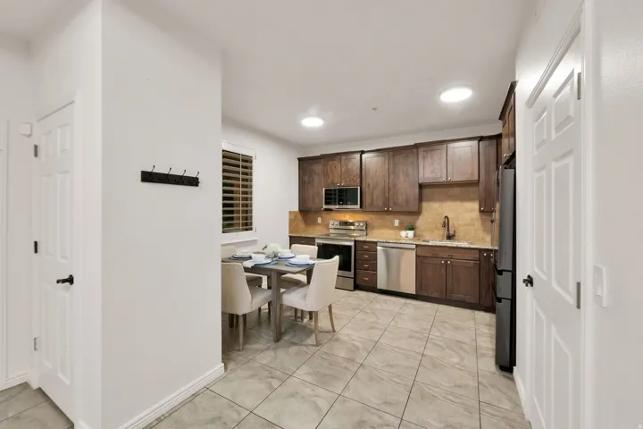 Kitchen featuring wood-finish cabinetry, granite countertops, and stainless steel appliances