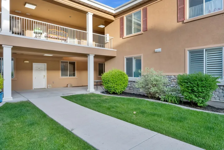 Exterior building with stucco finish, stone accent detailing, and multiple windows