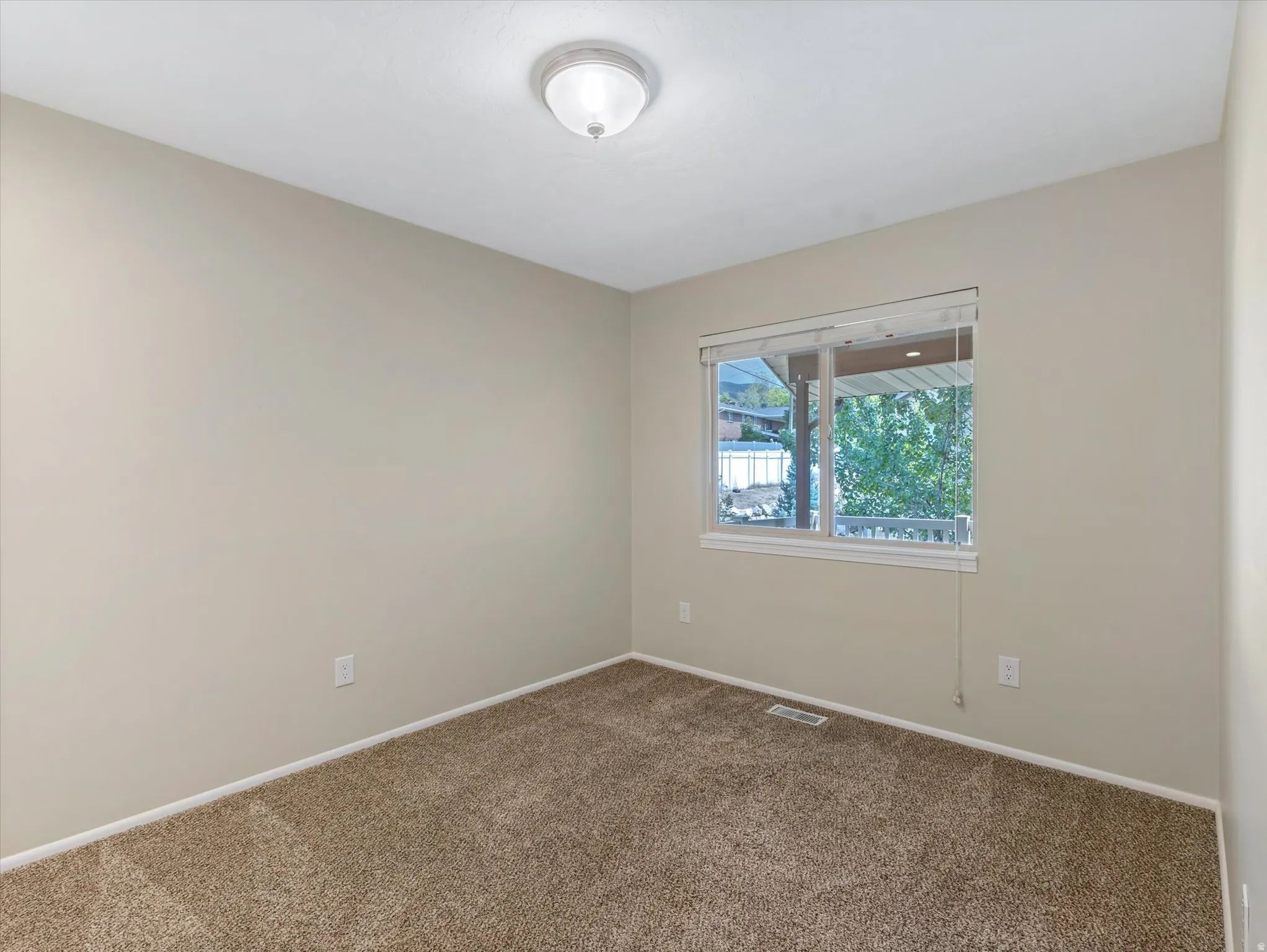 Neutral-toned walls complement plush carpeting