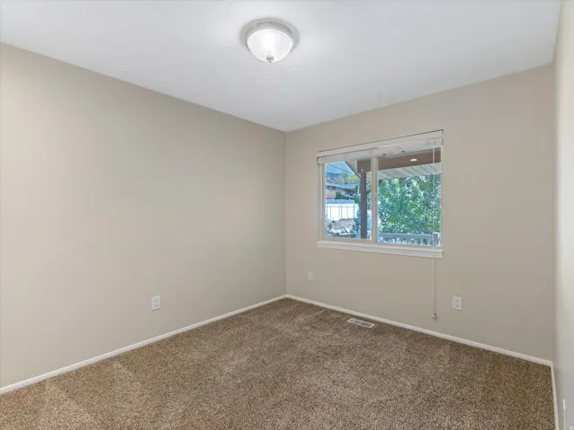 Neutral-toned walls complement plush carpeting