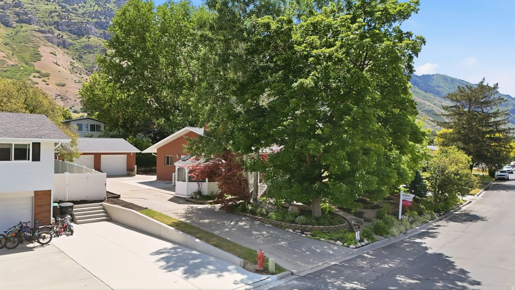 Extensive paved driveway with a lower-level garage entry