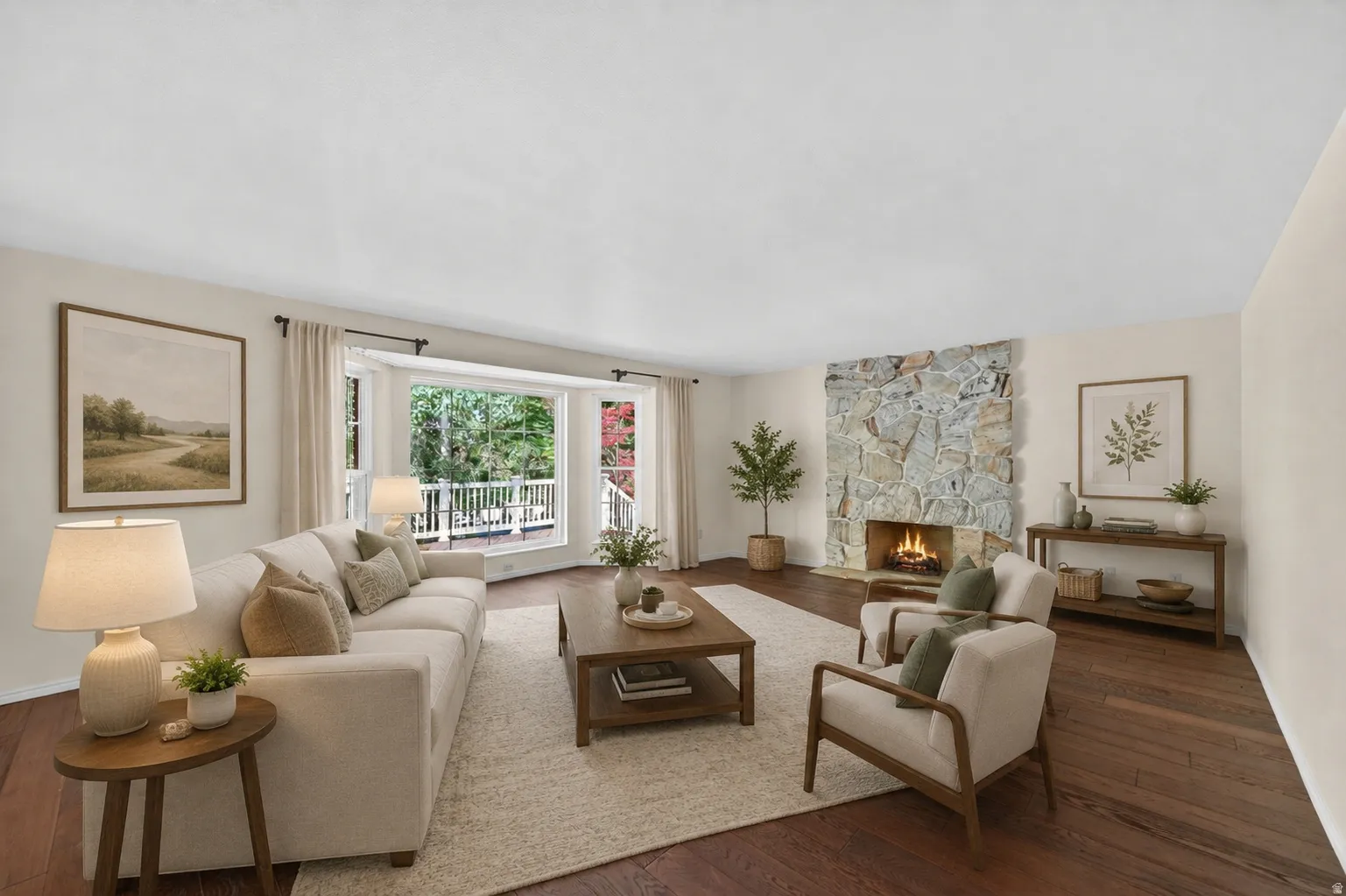 Living area featuring wide plank wood-finish flooring, a stone fireplace, and a bay window