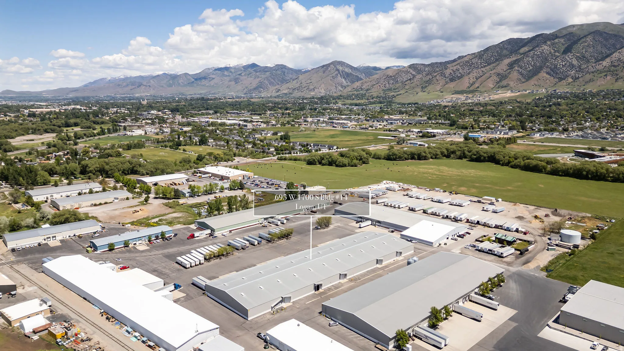 Expansive commercial property featuring multiple large warehouse buildings with gray metal roofs