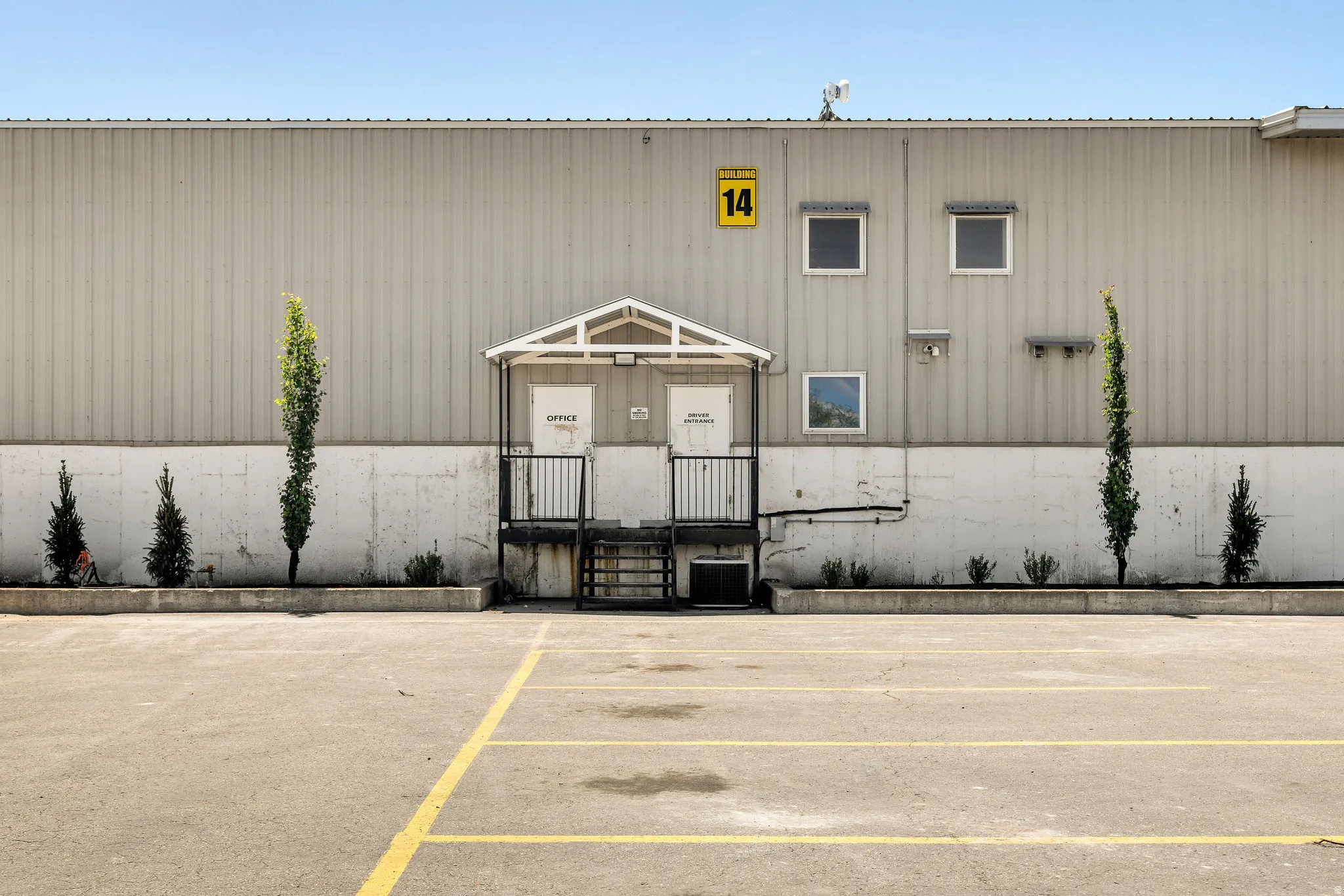 Exterior building featuring corrugated metal siding and a concrete lower facade