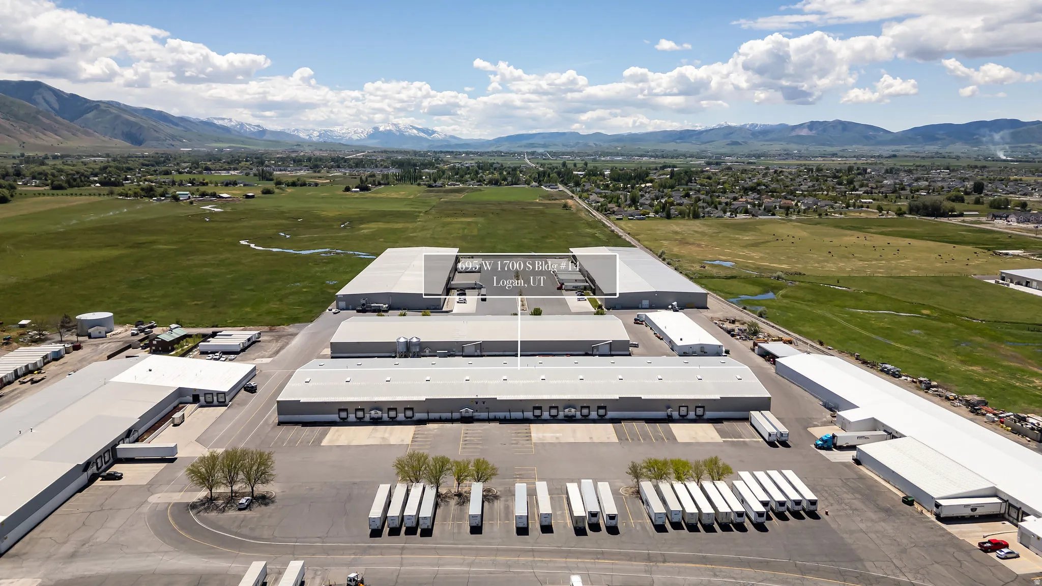 Expansive industrial complex featuring multiple large warehouse buildings with extensive truck parking and loading docks