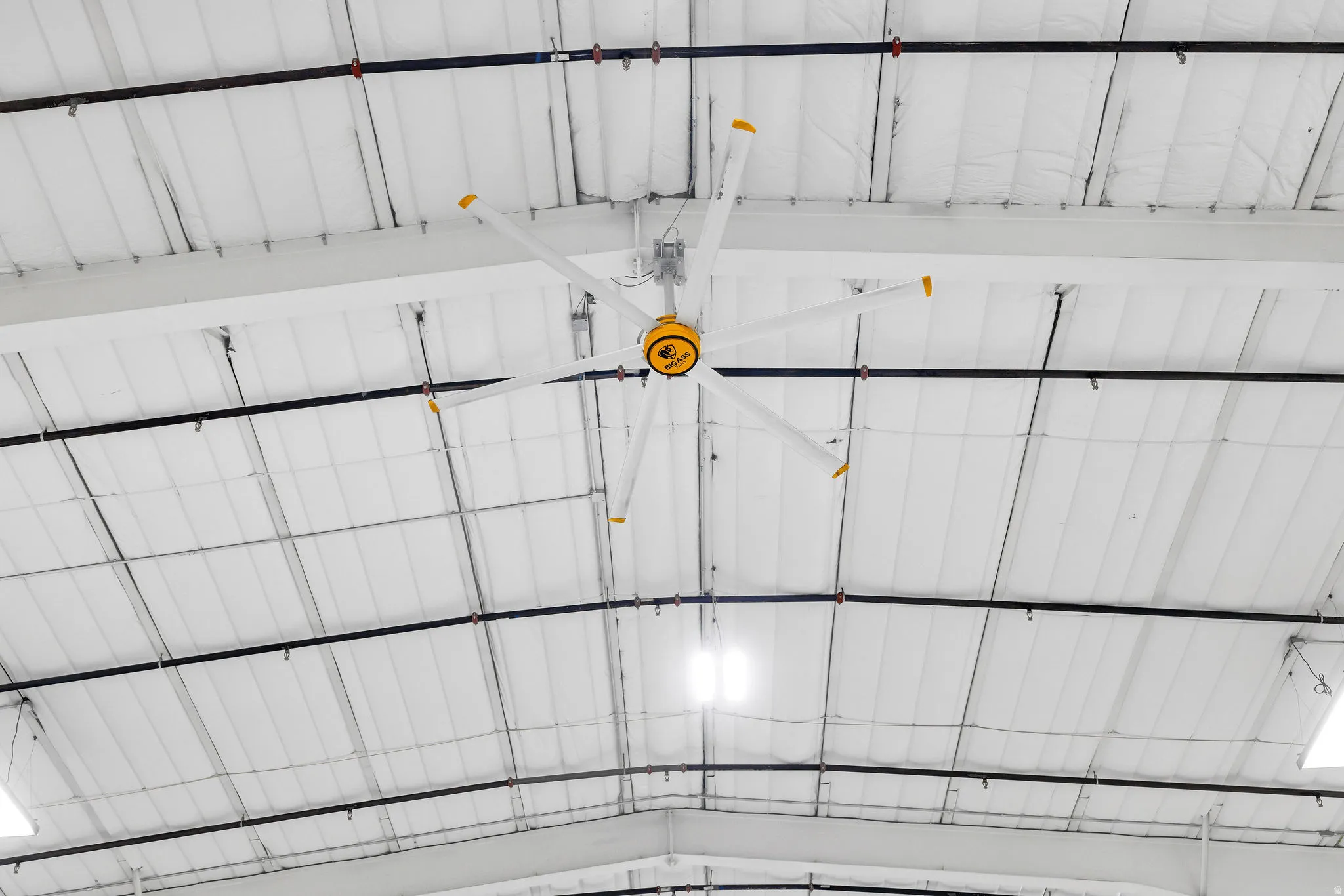 Commercial Property Image. Depicting a ceiling with a large industrial fan and exposed ductwork