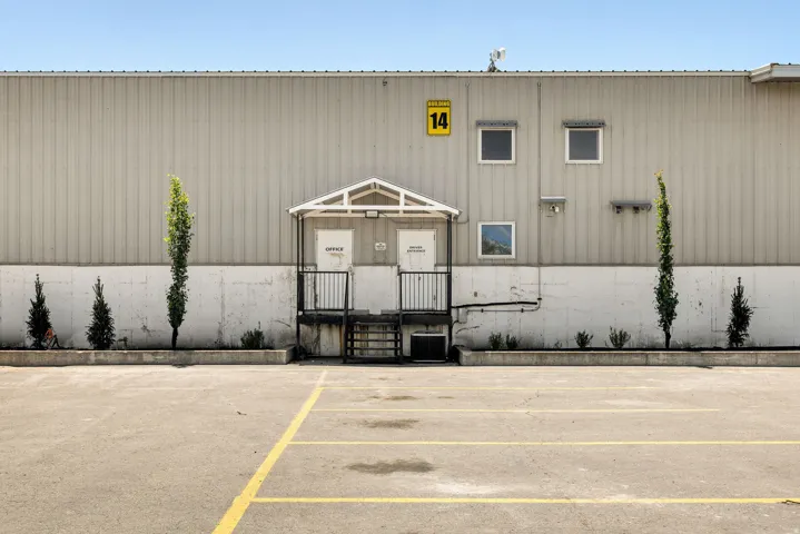Exterior building featuring corrugated metal siding and a concrete lower facade