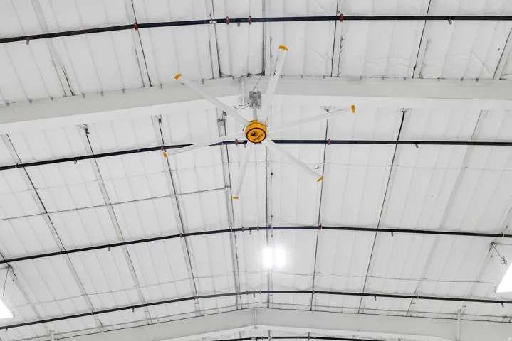Commercial Property Image. Depicting a ceiling with a large industrial fan and exposed ductwork