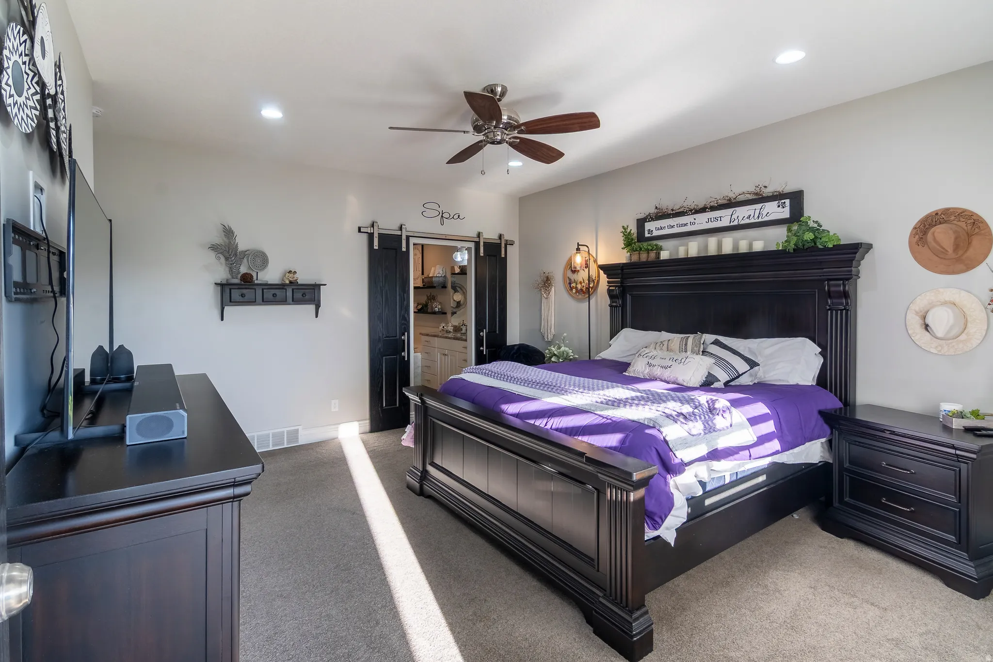Spacious bedroom featuring neutral wall tones, recessed lighting, and a ceiling fan