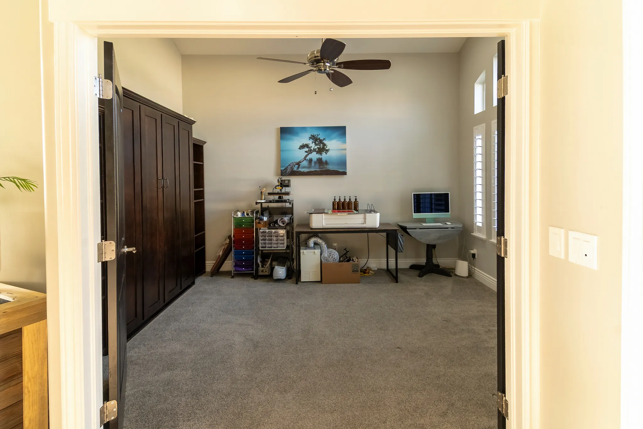 Spacious room featuring neutral wall tones and plush carpeting