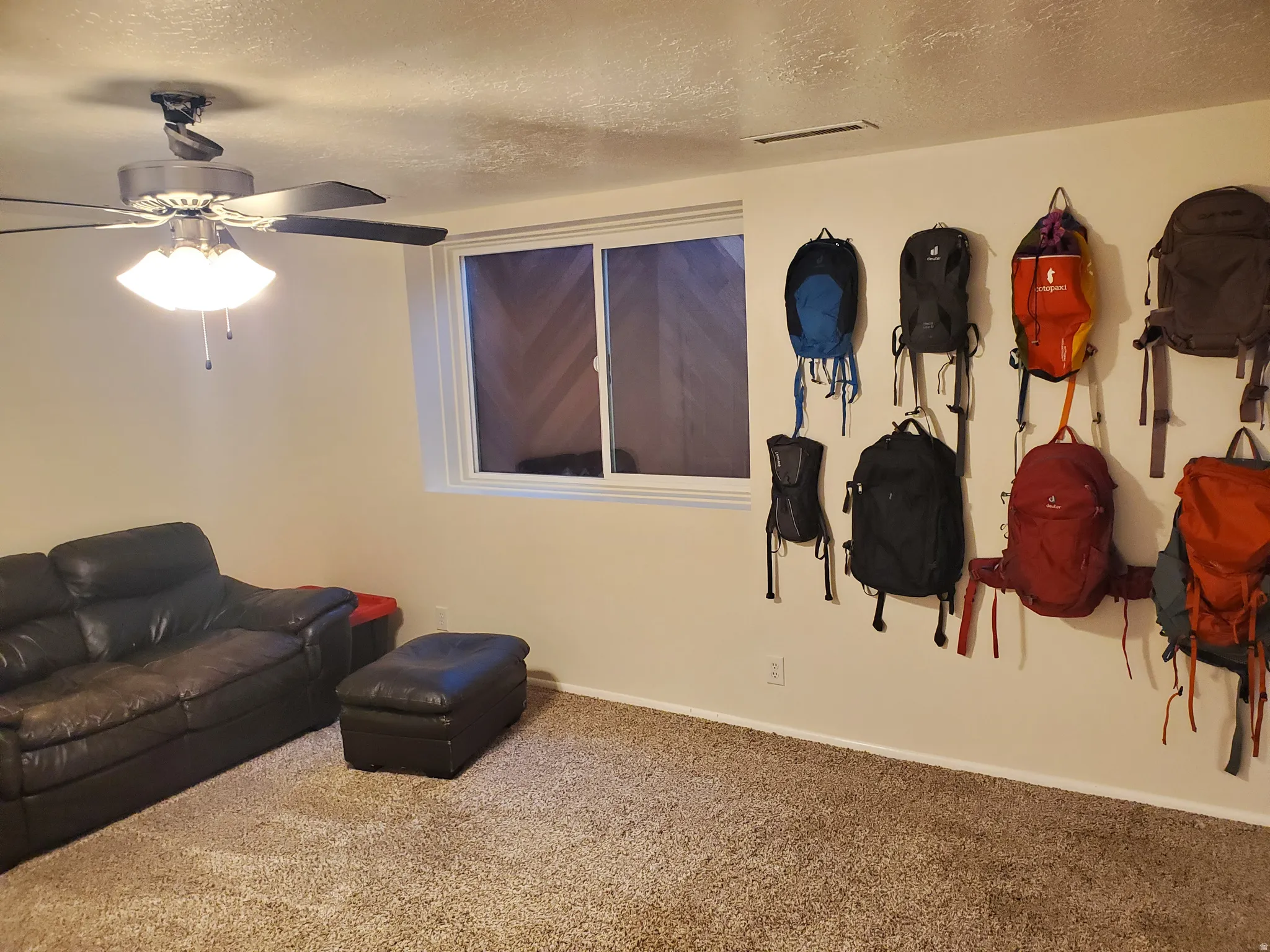 Recessed window with white trim, tan wall paint, and textured carpeting