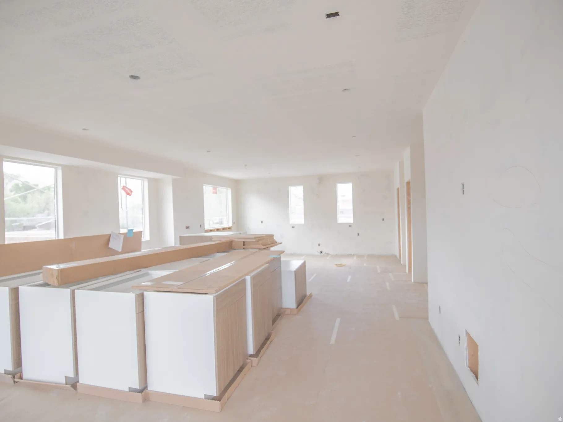 Spacious interior featuring multiple large windows and white-painted walls
