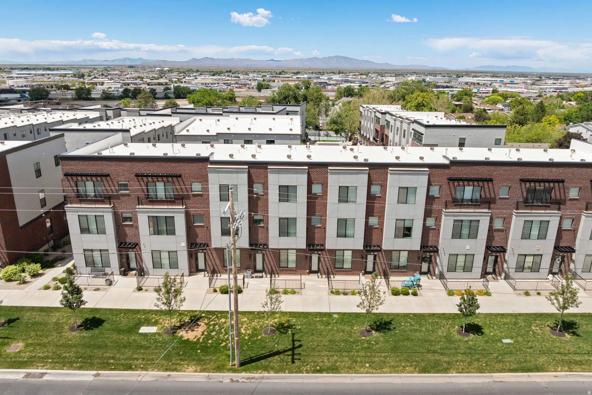 Modern townhome development featuring a brick and gray panel facade