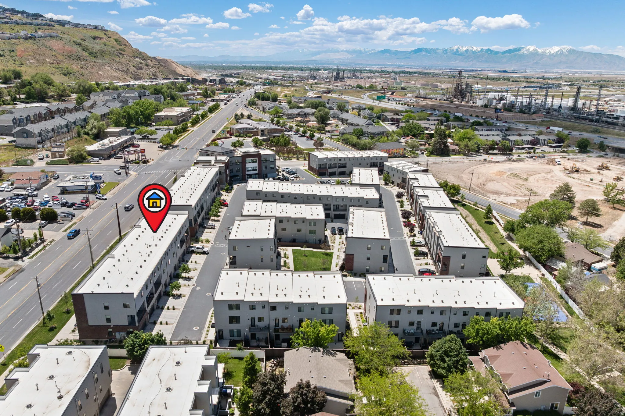 Aerial perspective of a modern townhome community featuring flat roofs and a uniform architectural style