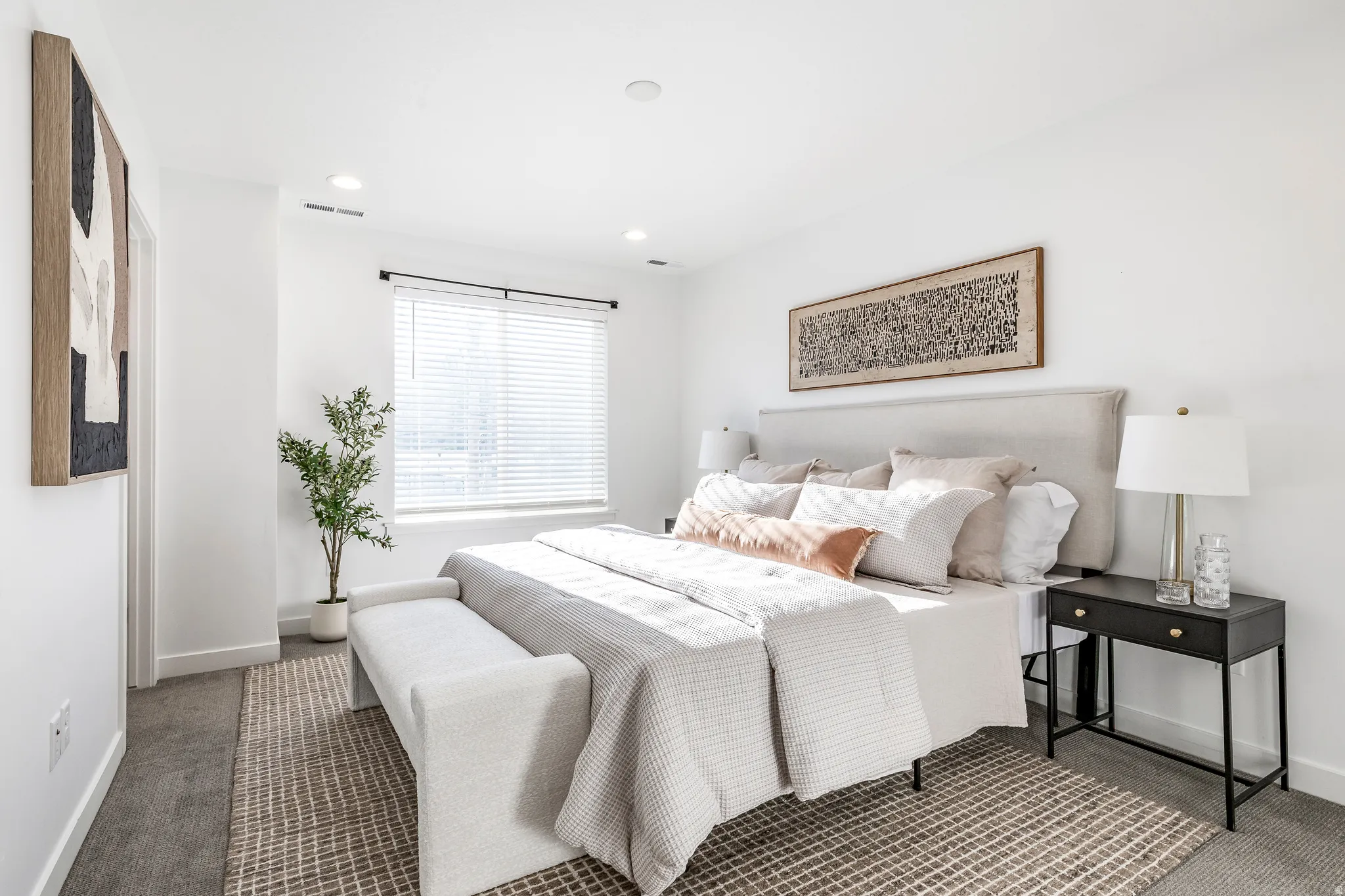 Bedroom featuring a window with blinds, recessed lighting, and a textured area rug over carpeting