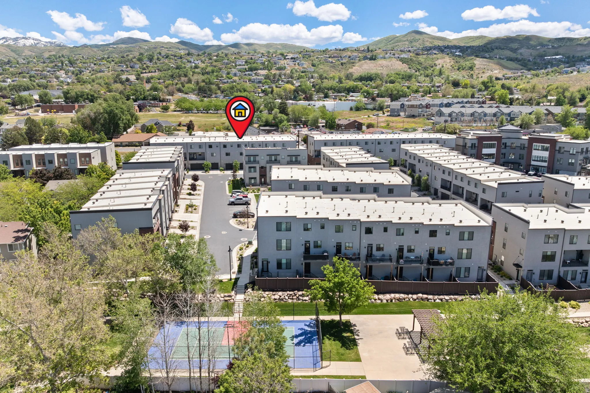Modern multi-story residential complex featuring private balconies, integrated garages, and flat roofs