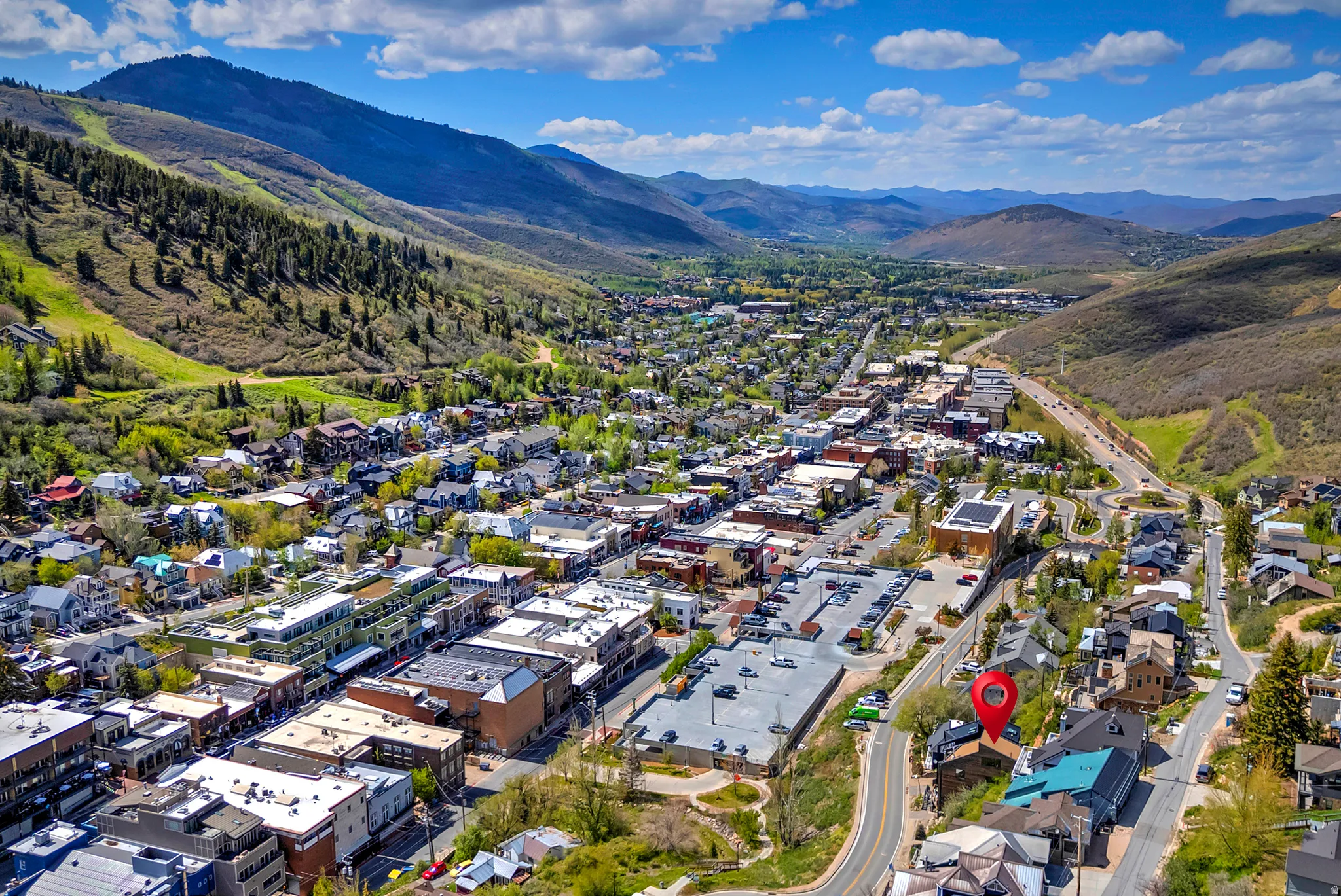 Aerial perspective highlighting a property within a mountain valley setting