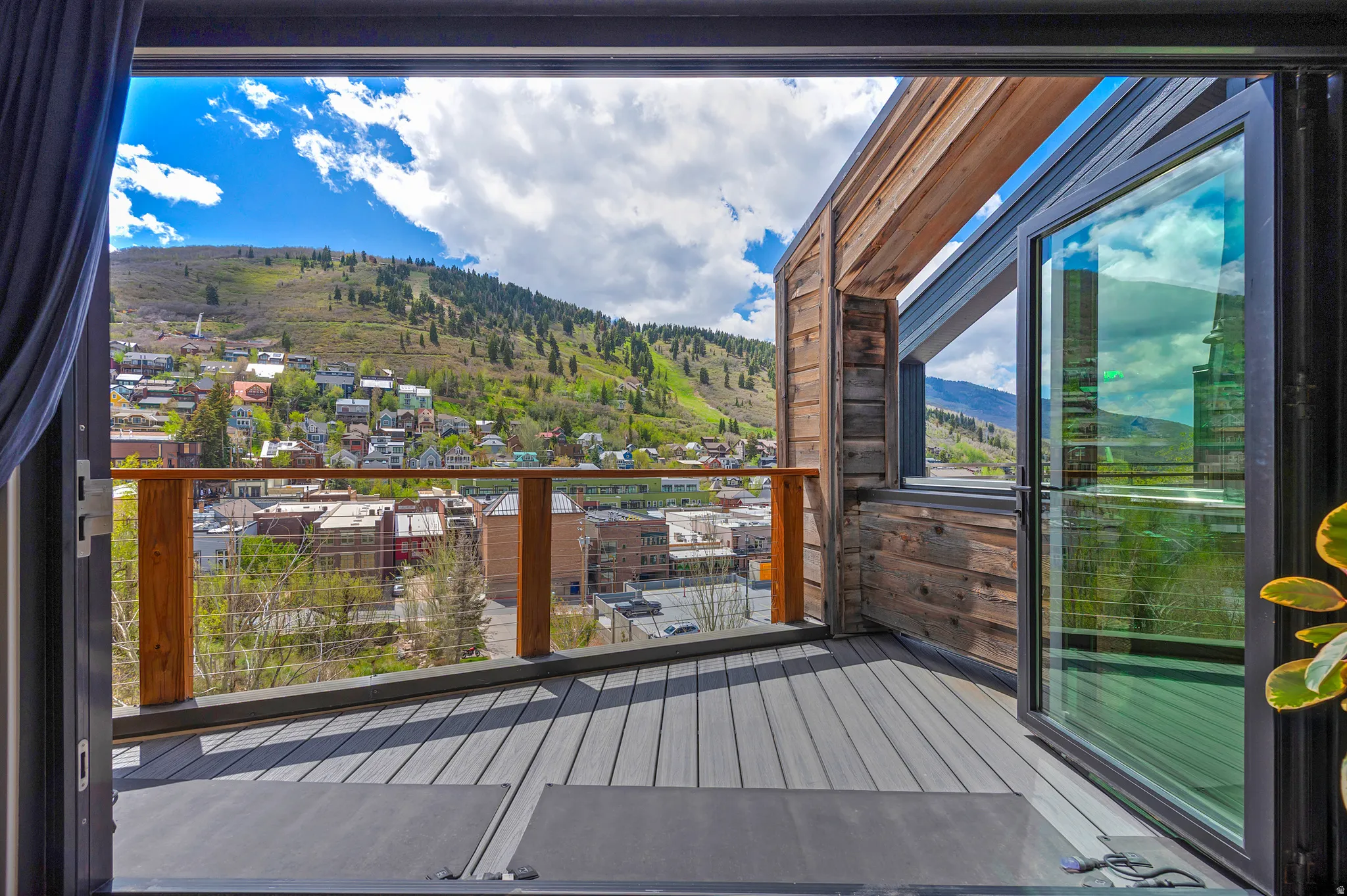Expansive outdoor deck featuring wood-finish composite decking and a cable railing system