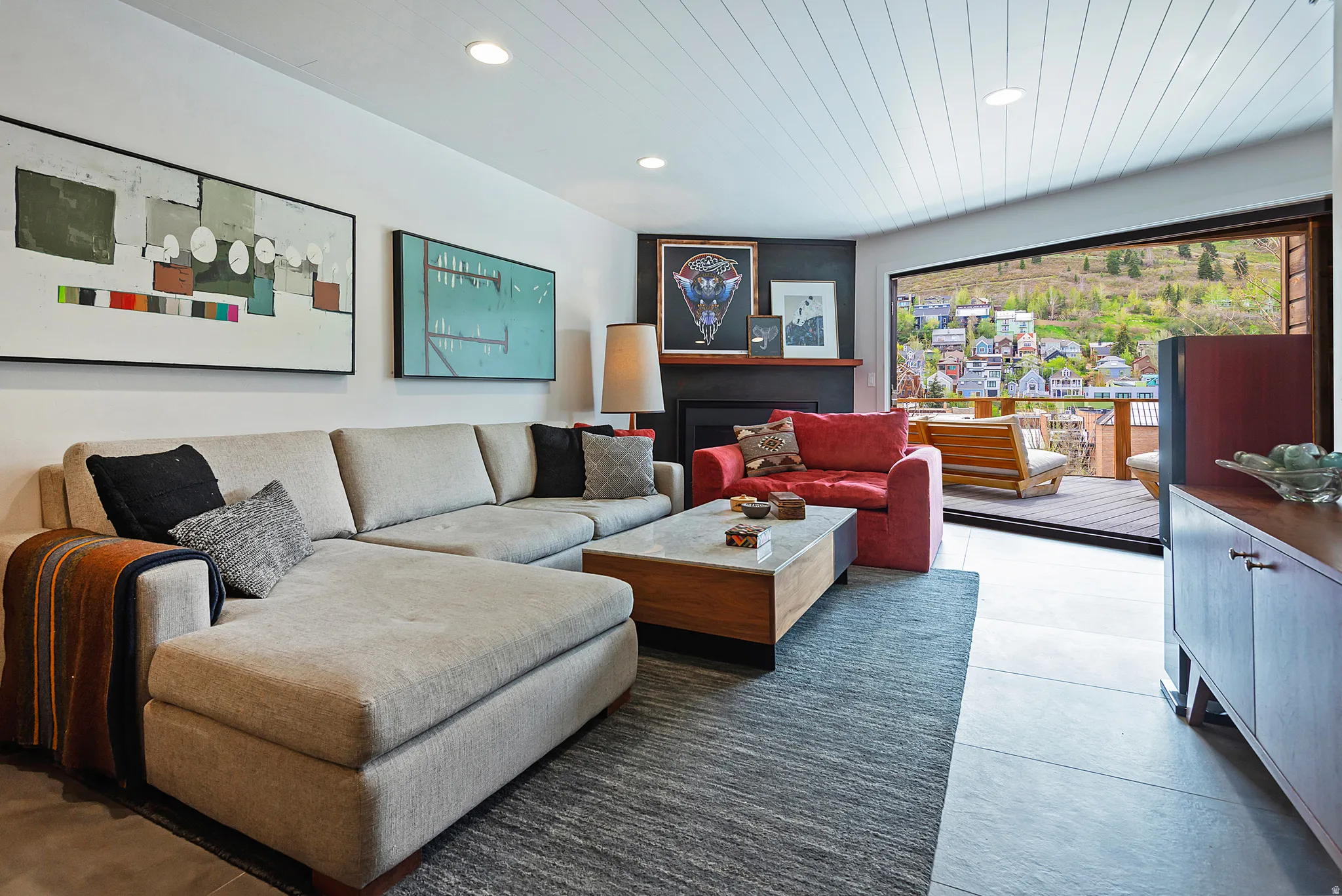 Living area featuring a shiplap ceiling, recessed lighting, and large format floor tiling