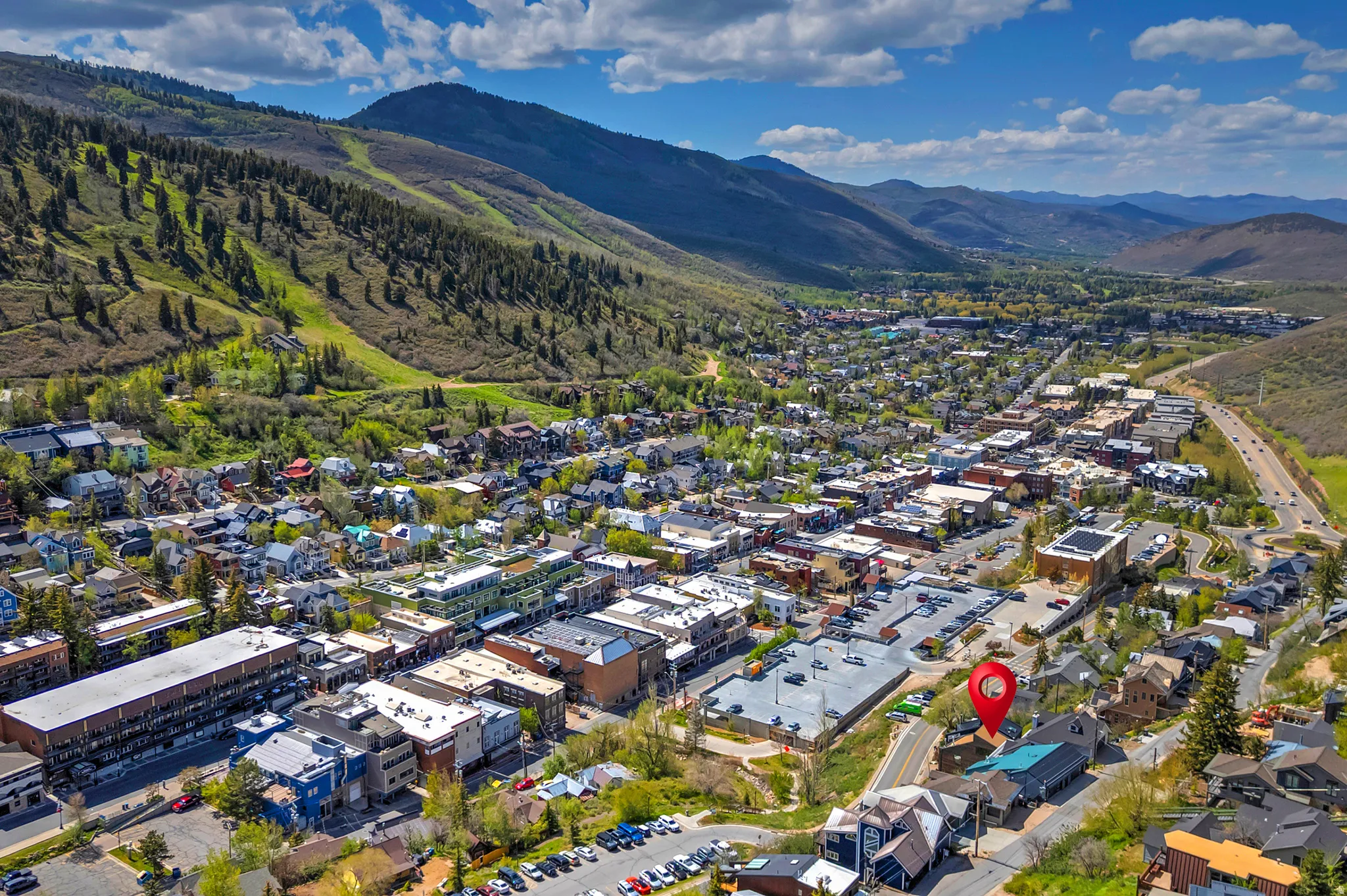 Aerial perspective of a mountain town featuring commercial and residential buildings