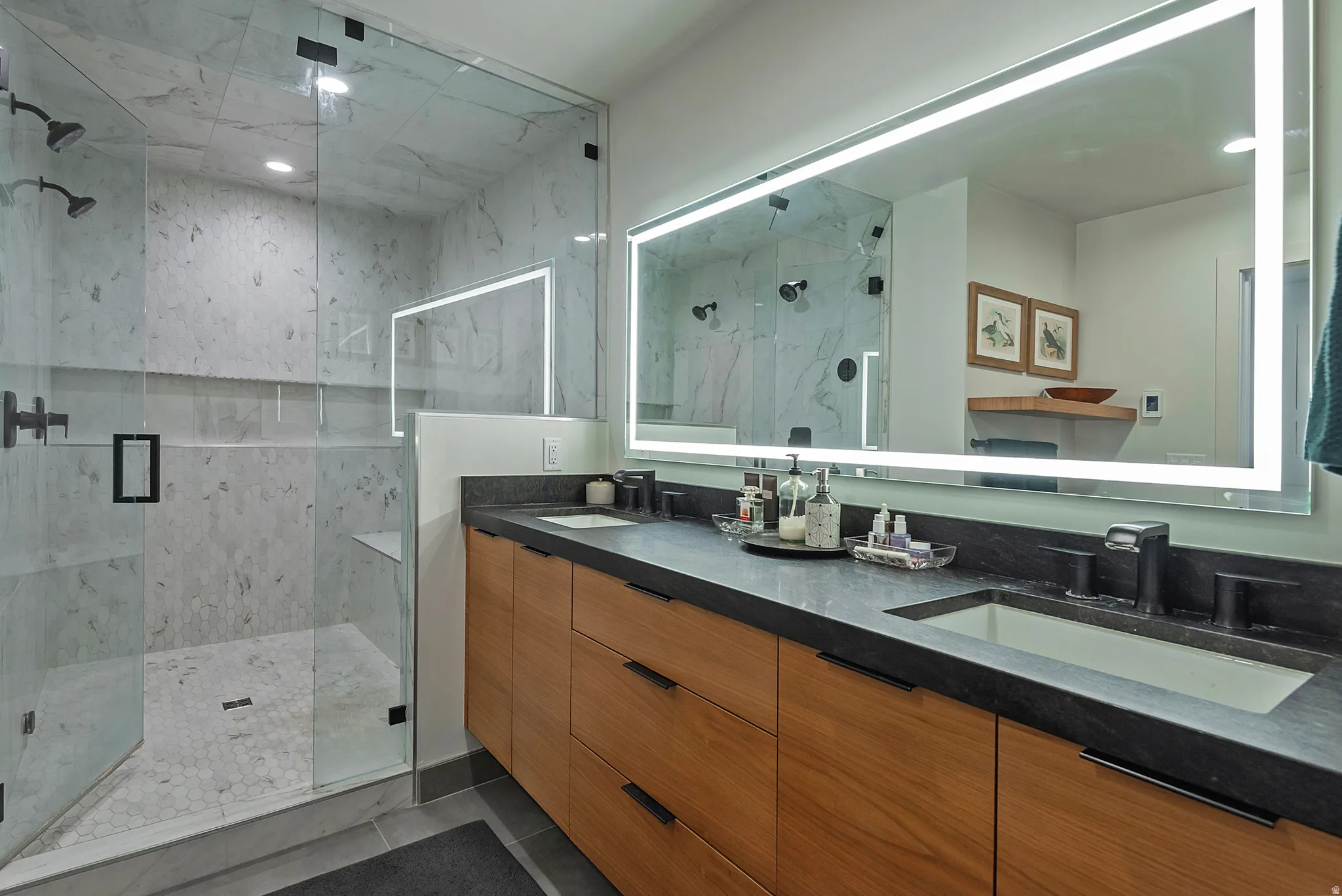 Walk-in shower with clear glass enclosure and dual shower heads