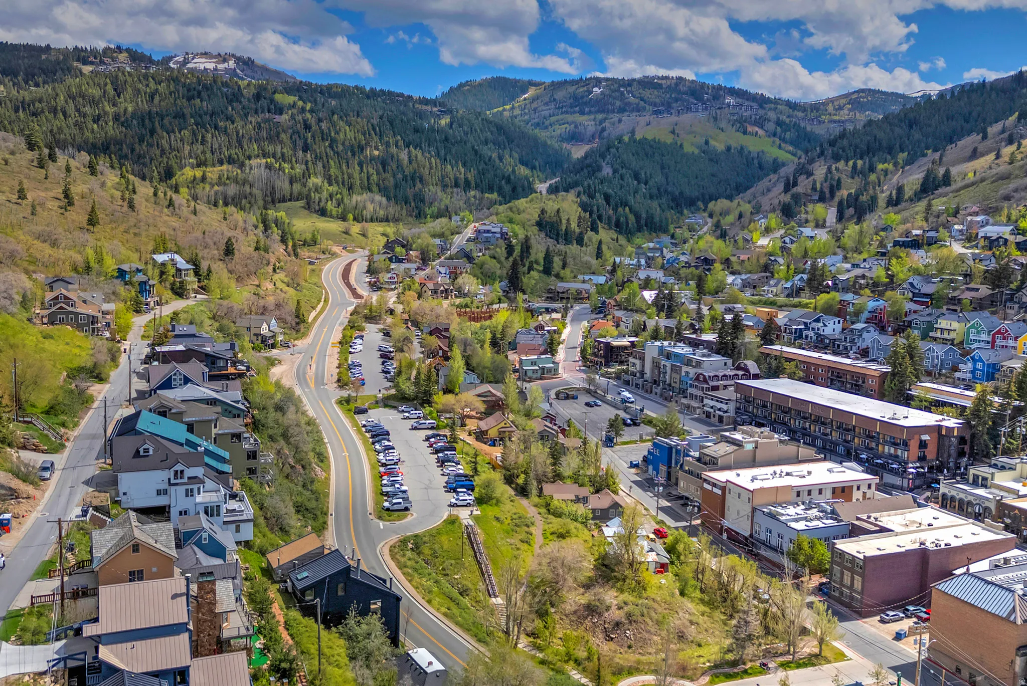 Mountain community featuring diverse architectural styles, winding roads, and extensive green spaces
