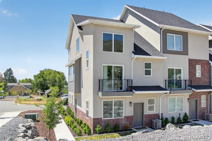 Contemporary multi-story exterior with a combination of stucco and brick siding