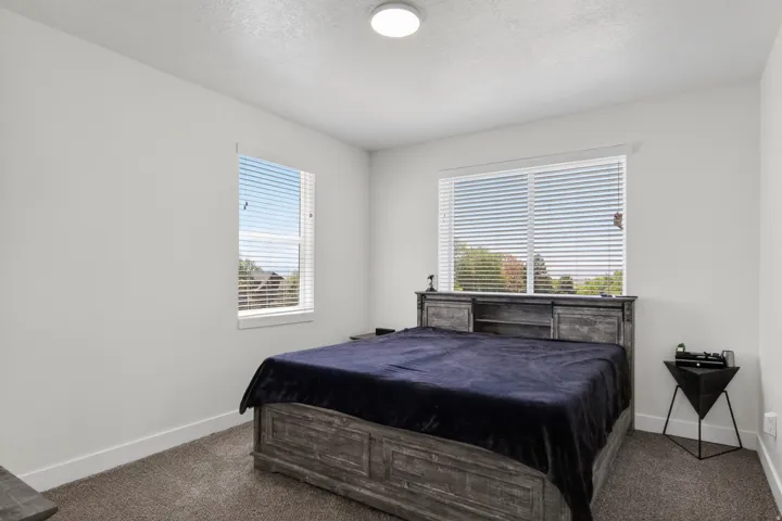 Primary bedroom with a walk in closet an ensuite bathroom with incredible views
