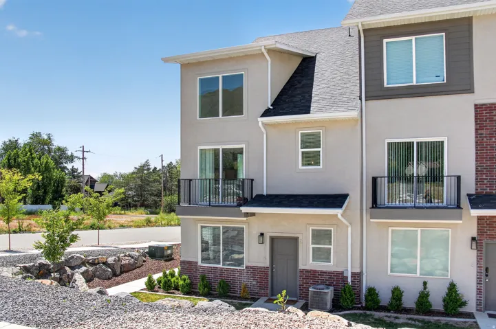 Contemporary multi-story exterior with stucco and brick accents