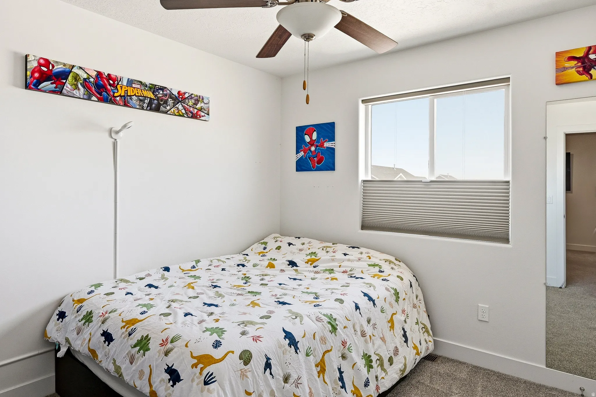 Room featuring a ceiling fan with integrated lighting, a window with cellular shades, and neutral wall tones