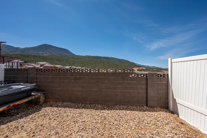 Xeriscape landscaping with gravel and a concrete block privacy wall