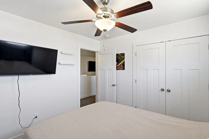 White interior walls complemented by a ceiling fan with wood-finish blades and integrated lighting