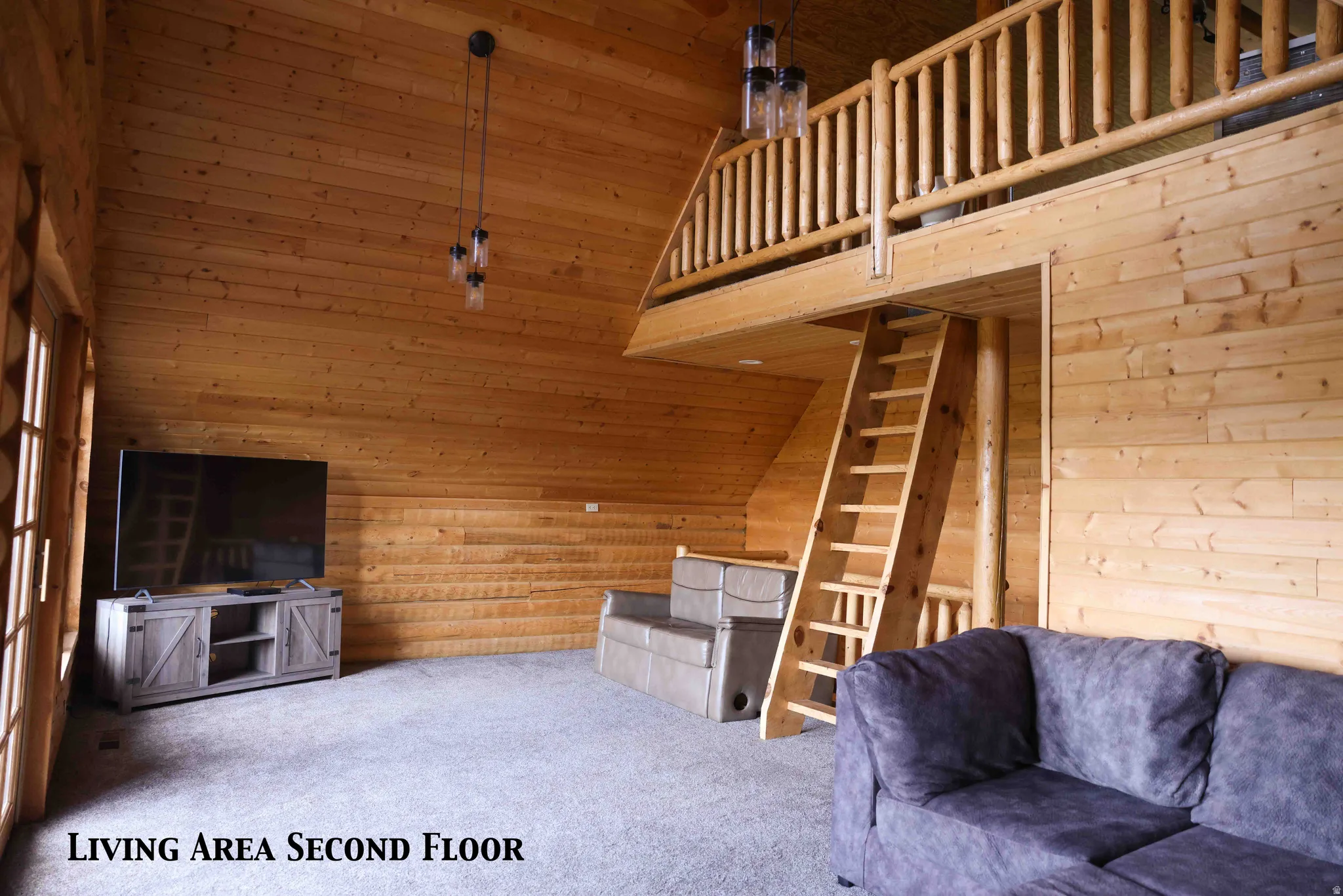 Open-concept living space featuring wood paneling, sloped ceilings, and wood-finish flooring