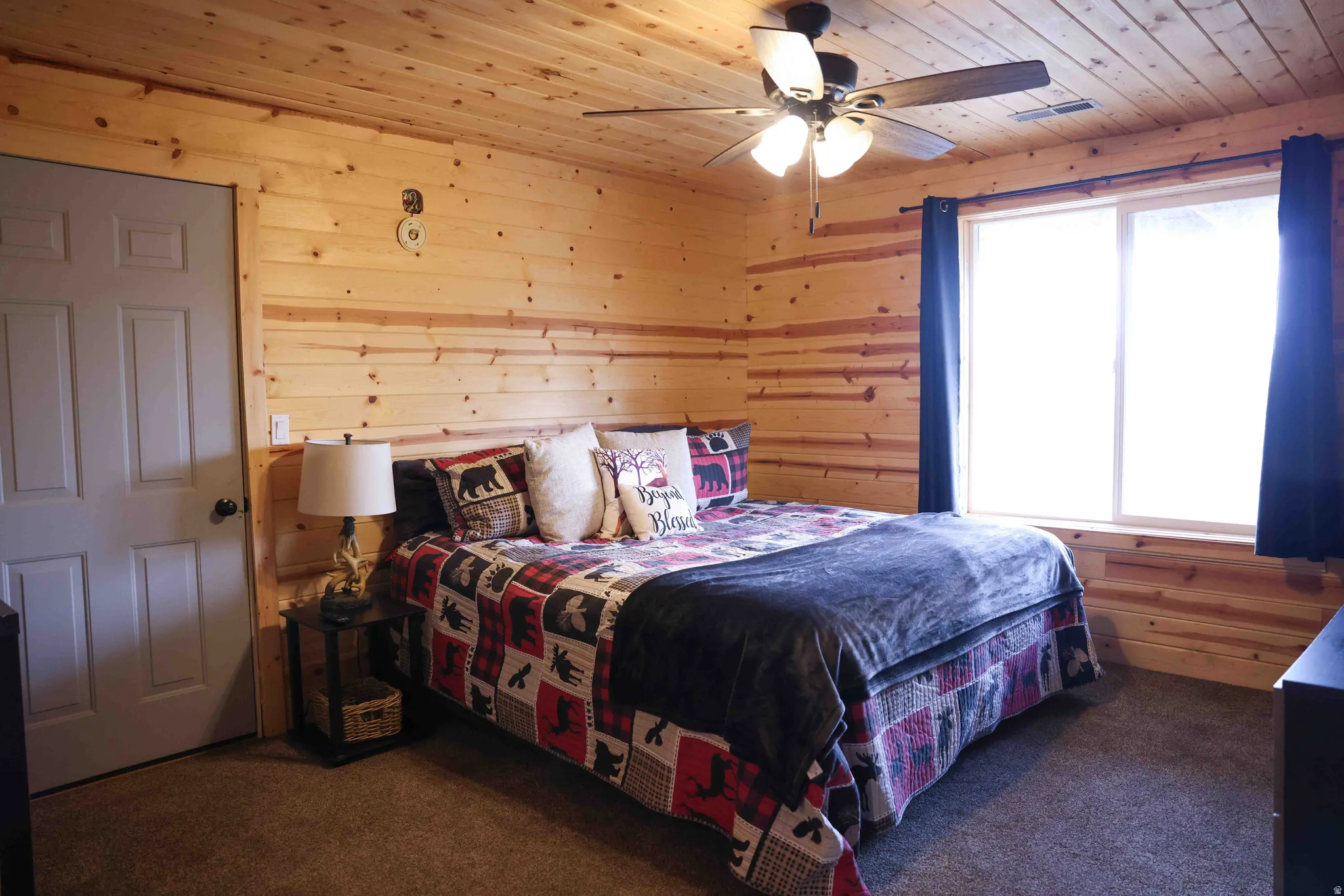 Wood-paneled walls and ceiling with a ceiling fan light fixture