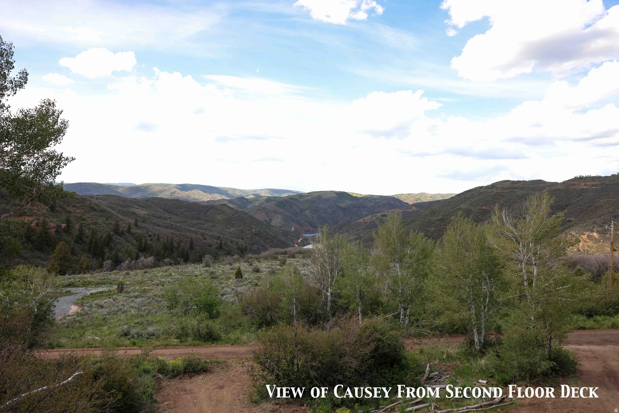 Expansive natural landscape with rolling hills and distant mountains