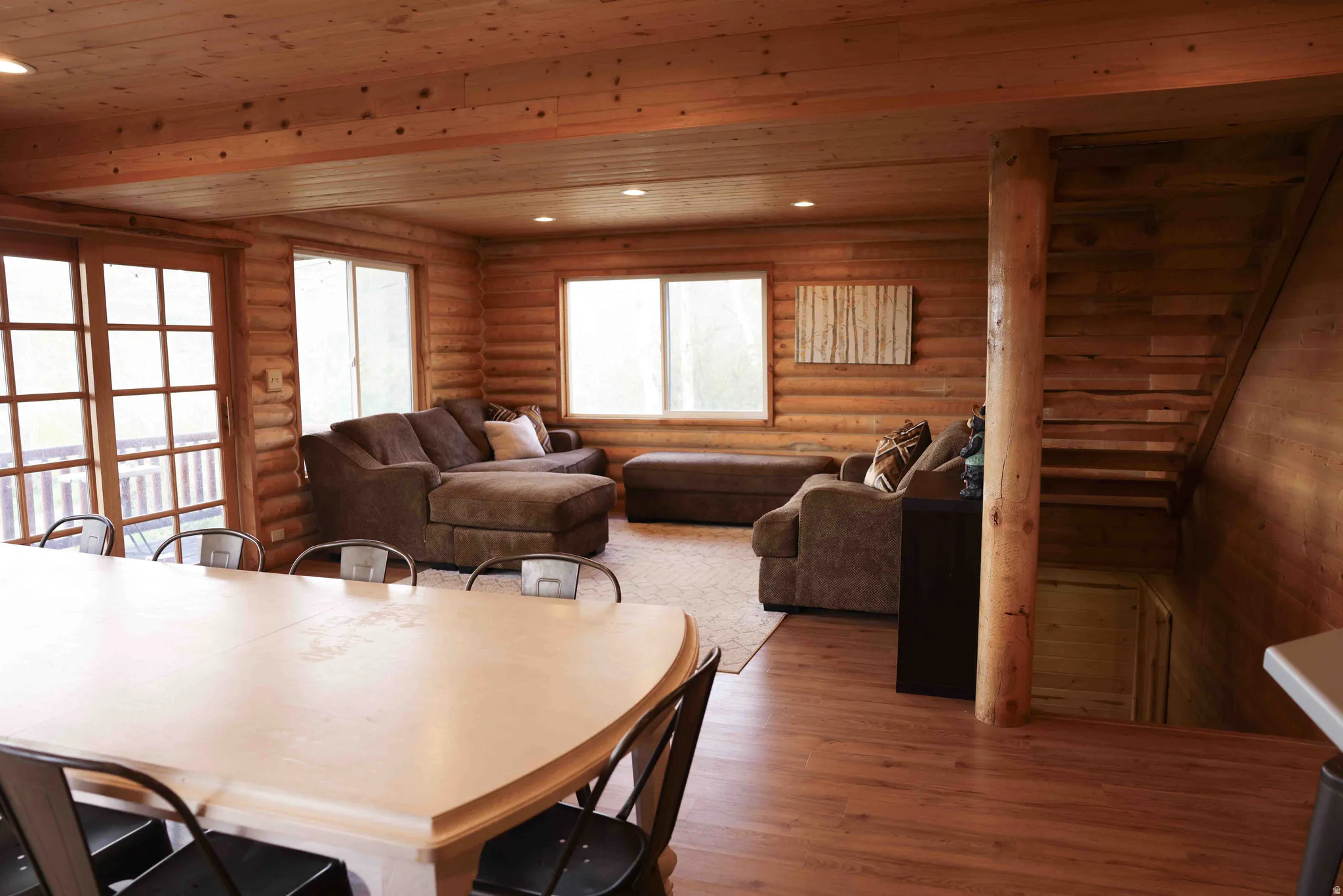 Spacious room featuring wood-finish flooring, wood plank walls, and a wood plank ceiling with recessed lighting