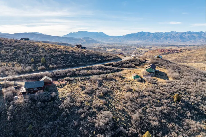 Fall views. Elevated mountain property featuring multiple structures and natural landscaping