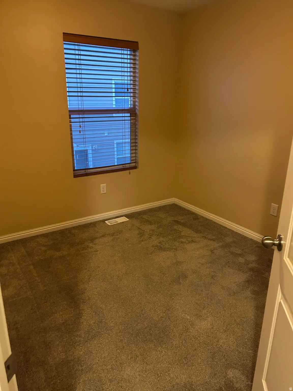 Guest bedroom with carpet flooring and closet