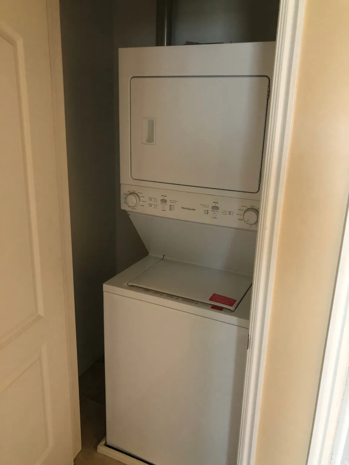 Space-saving stacked washer and dryer unit within a dedicated utility closet