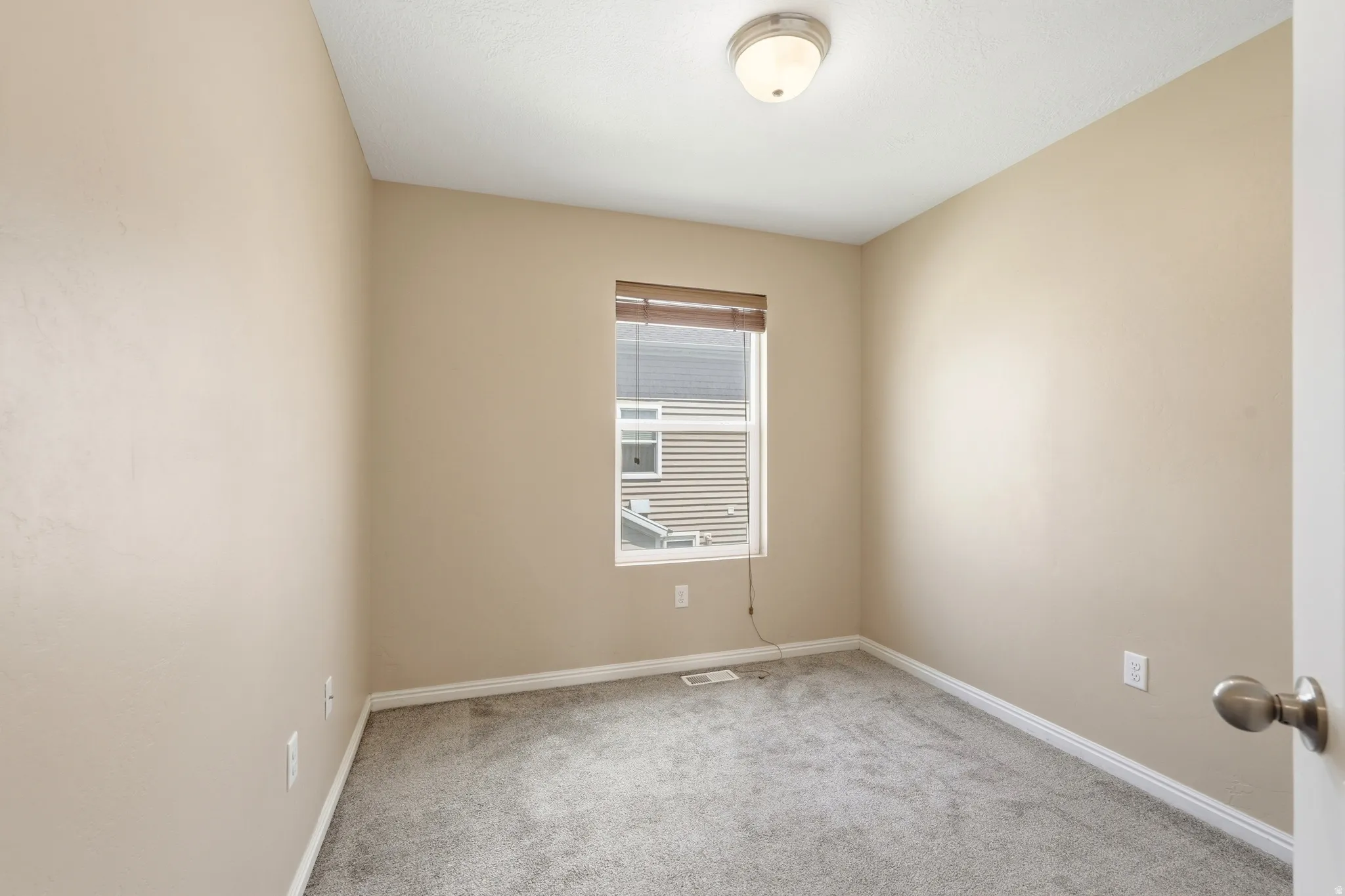 Bedroom featuring neutral paint, gray carpeting, a flush mount ceiling light, and white trim